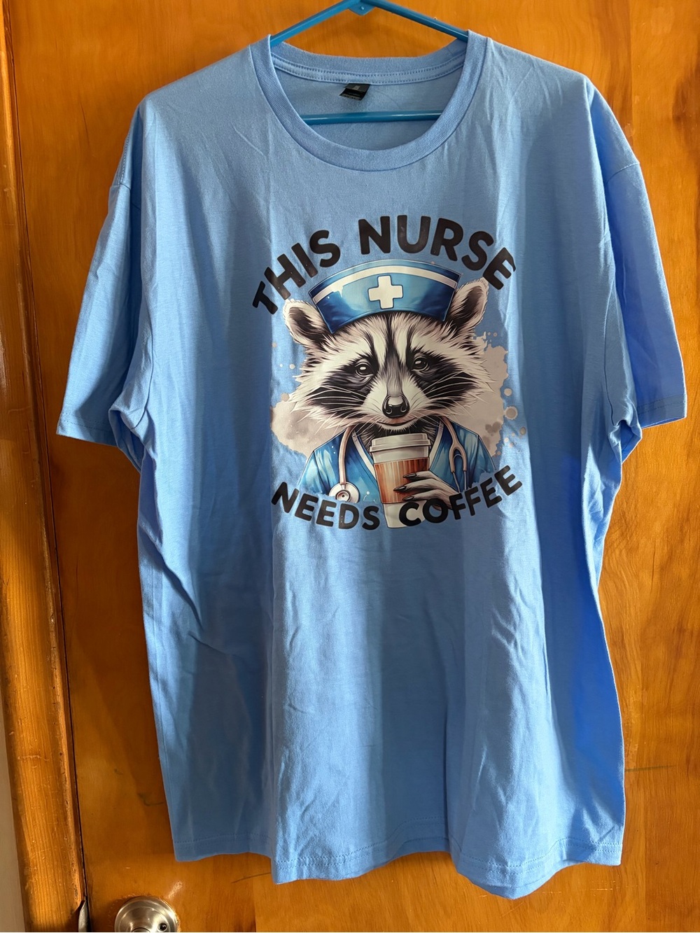 Gildan Light Blue Raccoon Nurse 'This Nurse Needs Coffee' Tee